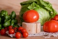 Cherry tomatoes, cabbage on a deervian background. preparation of salad. Summer concept of proper healthy eating. Royalty Free Stock Photo