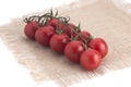 Cherry tomatoes on a canvas napkin on a white background Royalty Free Stock Photo