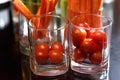 Cherry tomatoes celery and carrots in glass glasses Royalty Free Stock Photo