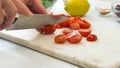 Chef cuts tomatoes. Vegetable salad recipe