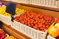 Cherry tomatoes on the counter of the vegetable market. Close-up and top view of fresh vegetables on store shelves. Royalty Free Stock Photo