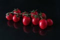 Cherry tomatoes covered isolated on black background Royalty Free Stock Photo