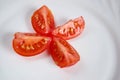 cherry tomatoes cut into four pieces on white Terence. close up. vegetarian healthy food. Royalty Free Stock Photo