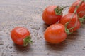 Cherry tomatoes on a dark table. A bunch in drops of water. Royalty Free Stock Photo