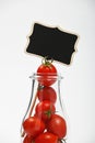 Cherry tomatoes in glass bottle over white Royalty Free Stock Photo