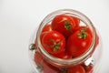 Cherry tomatoes in glass jar over white Royalty Free Stock Photo