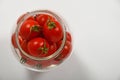 Cherry tomatoes in glass jar over white Royalty Free Stock Photo