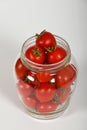 Cherry tomatoes in glass jar over white Royalty Free Stock Photo