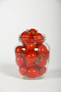 Cherry tomatoes in glass jar over white Royalty Free Stock Photo