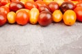 Cherry tomatoes on gray marble background. Copyspace