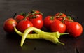 Cherry tomatoes, green chili, dark background Royalty Free Stock Photo