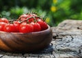 Cherry tomatoes in heart shape plate on old wooden surface, space for text Royalty Free Stock Photo