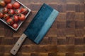 Cherry tomatoes and japan knife on wooden brownn handmade cutting board