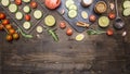 Cherry tomatoes, lime, spices, cucumber, laid out on a chopping board, with peppers, herbs border ,place text on wooden rustic Royalty Free Stock Photo