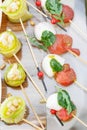 Zucchini rolls with pine nuts. Cherry tomatoes,mozzarella and Basil on skewers. . Pesto sauce. Tasty buffet table Royalty Free Stock Photo