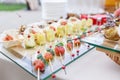 Zucchini rolls with pine nuts. Cherry tomatoes,mozzarella and Basil on skewers. . Pesto sauce. Tasty buffet table Royalty Free Stock Photo