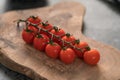 Cherry tomatoes on olive wood board Royalty Free Stock Photo