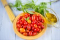 Cherry tomatoes, pasta, basil and olive oil on a wooden. Royalty Free Stock Photo