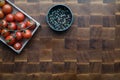 Cherry tomatoes and pepper on wooden brownn handmade cutting board