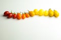 Cherry tomatoes in a row for color nuance on white background