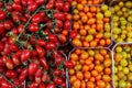 Cherry tomatoes of several varieties on the counter at the market.