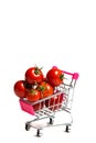 Cherry tomatoes and shopping cart on white background Royalty Free Stock Photo