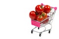 Cherry tomatoes and shopping cart on white background Royalty Free Stock Photo