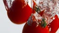 Cherry tomatoes splashing liquid closeup. Fresh garden vegetables drop bubbling Royalty Free Stock Photo