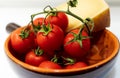 Cherry tomatoes with stem and cheese close up Royalty Free Stock Photo