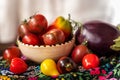 Cherry tomatoes various types, pepper and eggplant vegetable still life with drapery Royalty Free Stock Photo