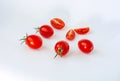 Fresh cherry tomatoes whole and cut on a white background. Space for text