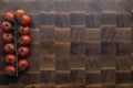 Cherry tomatoes on wooden brownn handmade cutting board