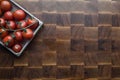 Cherry tomatoes on wooden brownn handmade cutting board