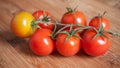 Cherry tomatoes on wooden cutting board in bambou tex