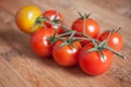 Cherry tomatoes on wooden cutting board in bambou tex