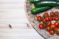 Cherry tomatoes and zucchini in a wicker basket Royalty Free Stock Photo