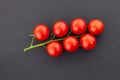 Cherry top view green branch tomato red mini black background