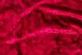 Cherry velvet. Velvet texture with folds. Colored background.