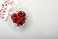 Cherry with water drops on heart shaped plate on white stone table. Fresh ripe cherries. Sweet red cherries. Top view. Rustic styl Royalty Free Stock Photo