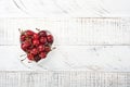 Cherry with water drops on heart shaped plate on white stone table. Fresh ripe cherries. Sweet red cherries. Top view. Rustic styl Royalty Free Stock Photo