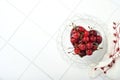 Cherry with water drops on heart shaped plate on white stone table. Fresh ripe cherries. Sweet red cherries. Top view. Rustic styl Royalty Free Stock Photo