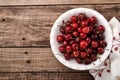Cherry with water drops on white bowl on dark brown stone table. Fresh ripe cherries. Sweet red cherries. Top view. Rustic style.