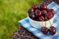 Cherry in a white bowl on a kitchen napkin. Healthy food concept