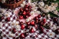 Cherry and white flowers on red checkered plaid, summer picnic in garden. Generative AI