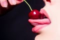 Cherry in woman mouth. Sexy tongue. Cherries on woman lips. Tongue lick cherry, macro, close up.