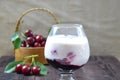 Cherry yogurt dessert and ripe cherry on a wooden table. Summer dessert. Royalty Free Stock Photo