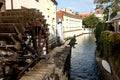 Chertovka river in Prague with an old water wheel