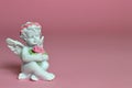 Cherub on pink background