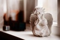 Cherub statuette on a windowsill