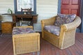 Outdoor seating arrangement on the aged porch of a 19th century American house.
